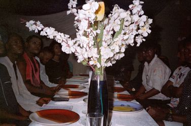 Sabelo Mlangeni, A farewell dinner with Daniel, Ruby, James Brown, Tonnex, Thom Smith, Mohammed, Sodiq, Mr Morrison, Lil B, Olumide, Icon, Nonso, (2019). Hand-printed silver gelatin print. Courtesy of the artist.