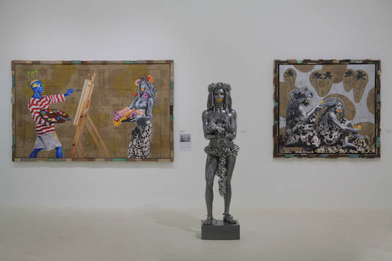 (Left to Right): Ashley Bickerton, Sanur Beach After Le Mayeur & Ni Pollok, (2014.) Mixed media on jute; Wahine Pa'ina (2015). Cast aluminum; Auntie Painting (2015). Oil and acrylic on jute with artist made frame.
