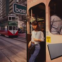 Woman getting off tram, Central, Hong Kong by Greg Girard contemporary artwork photography, print
