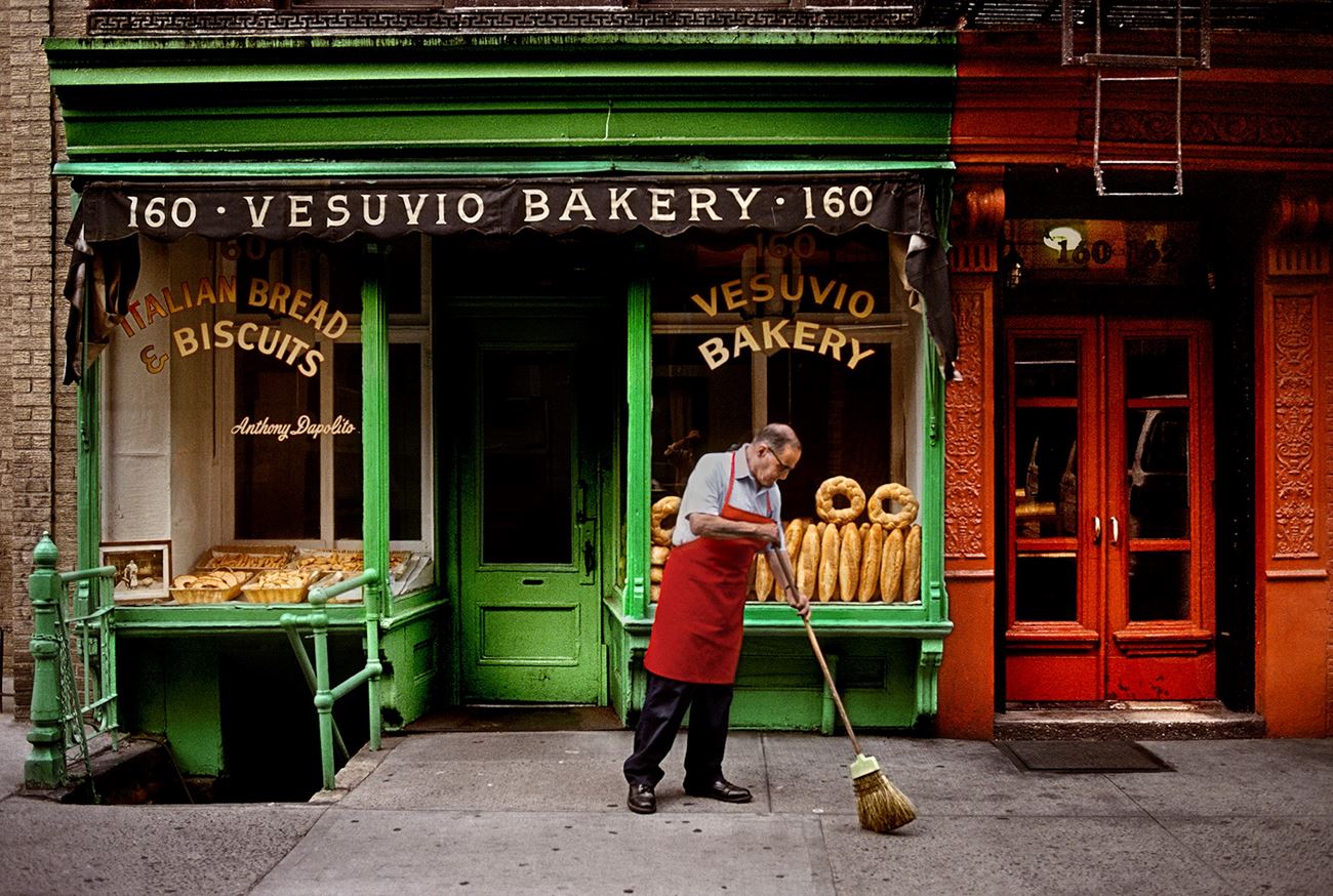 A man sweeps outside a bakery, New York, NY, USA, 1996 by Steve McCurry | Ocula