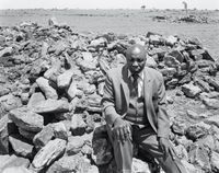 Luke Kgatitsoe in his house, bulldozed in February 1984 by the government after the forced removal of the people of Magopa, a black-owned farm, which had been declared a “black spot”, Ventersdorp district, Transvaal. 21 October 1986 (4_4588) by David Goldblatt contemporary artwork photography, print