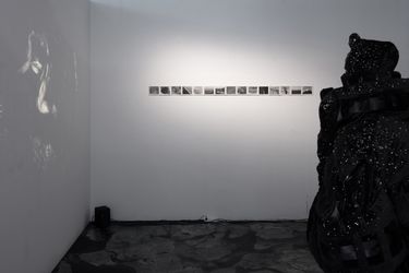 Exhibition view: only losers left alive (love songs for the end of the world) - Part One, Yeo Workshop, Singapore (10 July - 31 July 2021). Courtesy Yeo Workshop. Photo: Jonathan Tan. (left) XUE, Eclipse, 2021. NFT, Single-channel black and white video with sound,Duration: 8m 40s.(middle) Sarah Isabelle Tan, The Timeline: To a World Without Time, 2019-21. Black-and-white photographic handprints on silver gelatin fibre paper.(right) Hamkah Latib. The Mega Remix, 2020. Velvet, Nylon satin blend,swarovski crystals.