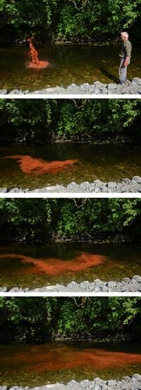 Crushed red river stone. Thrown into Scaur Water. Dumfriesshire, Scotland. 2 June 2016 by Andy Goldsworthy contemporary artwork photography