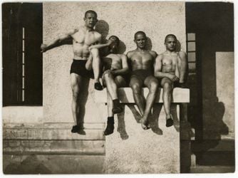 André Kertész, Group of four men in trunks sitting on a ramp (1914). Courtesy Bruce Silverstein.
