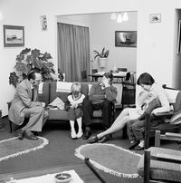 Dominee S M van Vuuren of the Dutch Reformed Church, Whitfield, at prayer with a family during a pastoral call, Boksburg (2_29233) by David Goldblatt contemporary artwork photography