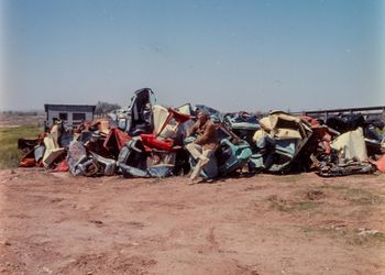 Chamberlain among his raw materials at Stanley Marsh 3's ranch, Toad Hall, Amarillo, Texas, 1972. Leo Castelli Gallery records. Archives of American Art, Smithsonian Institution, Washington, DC.