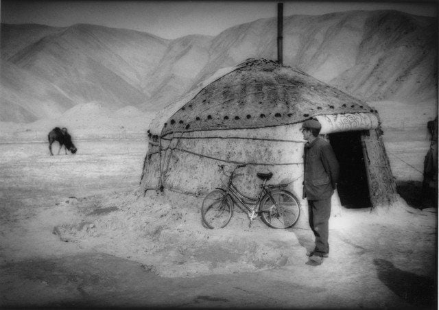 Kyrgyz herdsman watched his camels from outside his yurt,
beside Karakuli Lake, Pamir Mountains, Chinese Turkestan by James Whitlow Delano contemporary artwork
