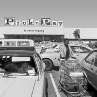 Hypermarket employee collecting trolleys, Boksburg, 1980 (2_28148) by David Goldblatt contemporary artwork photography