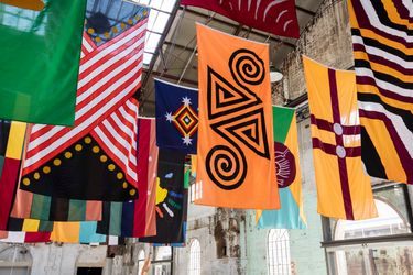 Archie Moore, United Neytions (2014–2017). Installation of 28 flags, polyester, nylon, zinc plated alloy. 28 parts in two sizes: 23 x 360 x 180 cm and 5x 180 x 180 cm. Exhibition view: The National: New Australian Art, Carriage works, Sydney (2017). Courtesy the artist and The Commercial. Sydney. Photo: Sofia Freeman.Image from:In Seoul, Contemporary Australian Art Reroutes 'Australia'Read FeatureFollow ArtistEnquire