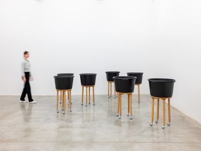 Chung Seoyoung, Road (1993). 7 pieces: wood, plastic bucket, casters, paint. Dimensions (each): 56 x 56 x 97 cm.