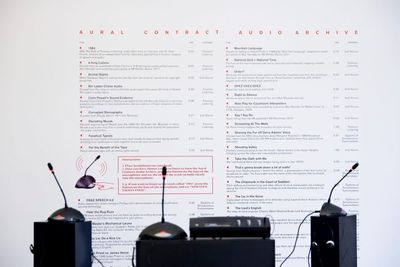 Lawrence Abu Hamdan, The Aural Contract Audio Archive (2010–ongoing). Three Bosch microphones, pre-programmed Mac mini, and large vinyl wall print.