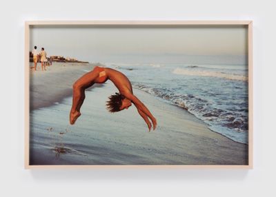 Peter Schlesinger, Photographer Reto Guntli doing a backflip, Fire Island Pines (1980). Archival c-print. Framed Dimensions: 68.6 x 104.1 cm. © Peter Schlesinger. Artwork credit: Phoebe D'Heurle.