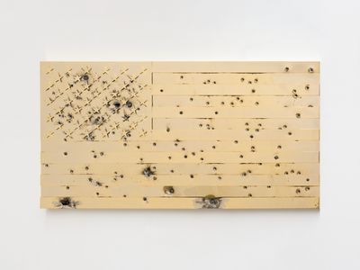 Maurizio Cattelan, Under (2024). 24-karat gold-plated, super-mirror stainless steel panel shot with different calibre weapons. 100 x 190 x 4 cm.