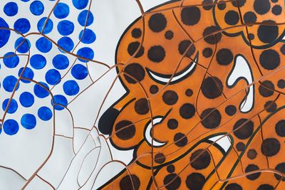 An oil and pastel painting of a Jaguar body spots, next to a blue and white pattern in the cracked-paint texture style of artist Adriana Varejão