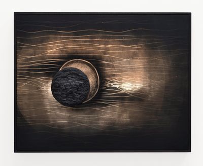 Teresita Fernández, Dark Earth (Eclipse) (2021). Solid charcoal and mixed media on chromed panel. 95.25 x 120.65 x 7.62 cm.