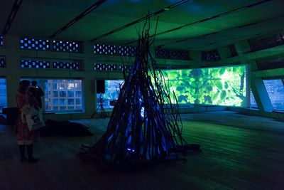 Larry Achiampong & David Blandy, Finding Fanon 3: Prologue (2016–2017). 4K UHD two-channel video colour with stereo sound and tree hut. Exhibition view: Finding Fanon with Larry Achiampong and David Blandy, Tate Modern, London (6 December 2016).