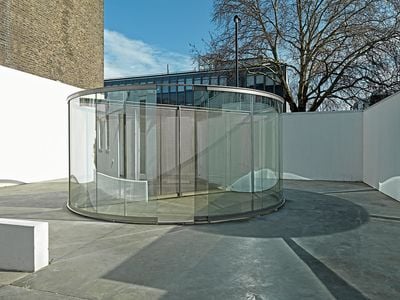 Dan Graham, 2-Way Mirror Cylinder Bisected By Perforated Stainless Steel (2011–12). Stainless steel, perforated steel, 2-way mirror. 230 cm x 520 cm x 90.6 cm. Exhibition view: Dan Graham: Pavilions, Lisson Gallery, London (21 March–28 April 2012). © Dan Graham.