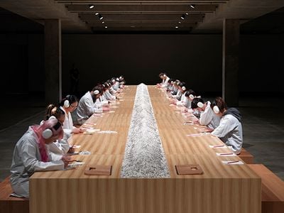 Marina Abramović, Counting the Rice (2015). Exhibition view: Marina Abramović, Solo Exhibition–Private Archaeology, (13 June–5 October 2015).  Exercise for public participation from a series of workshops entitled Cleaning the House (1979–); table, chairs, pencils, paper, white rice, black lentils, instructions for the public, duration limitless.