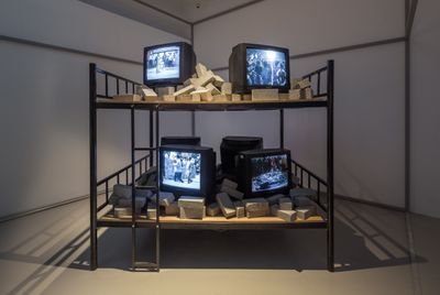 Lin Yilin, Hotbed (2003). Steel frame bunk bed, bricks, six-channel video. Exhibition view: Canton Express: Art of the Pearl River Delta, M+, Hong Kong (23 June–10 September 2017). Gift of Guan Yi (2013).