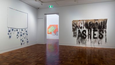 Raquel Ormella, Return to the beginning (2013). Nylon. 250 x 375 cm; Golden soil #3 (2016). Acrylic, hi-vis fabric and poly-cotton. 186 x 186 cm; Wealth for toil #5 (2017–2018). Charcoal, acrylic paint, hessian. 220 x 270 cm (left to right). Exhibition view: I hope you get this: Raquel Ormella