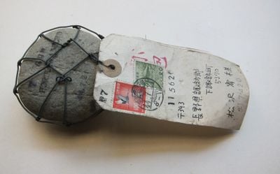 Horikawa Michio, The Shinano River Plan: 11 (1969). Stone, wire, mail tags, addressed to Matsuzawa Yutaka. 4.5 x 18 x 8 cm. Collection of Matsuzawa Kumiko. 