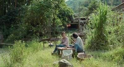 Film still woman and man sitting in the wilderness chatting
