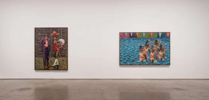 Two paintings by Derek Fordjour hang in a white gallery space. The left-hand painting is portrait format and pictures a woman in show dress accompanied by a man in a purple suit and bowler hat. The right-hand painting pictures a group of synchronised swimmers leaping out of a swimming pool. class=