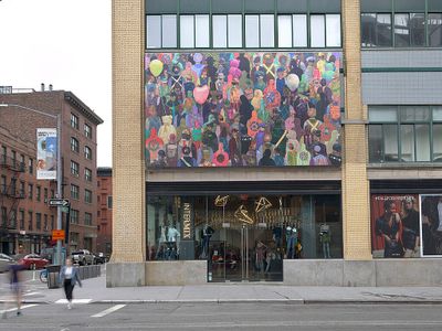 A mural by Derek Fordjour on the outside of the Whitney Museum of American Art shows a crowd of people, their clothing in varying shades of colour.