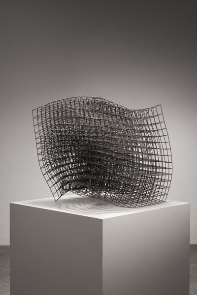 Welded steel wave sculpture on white bloc  