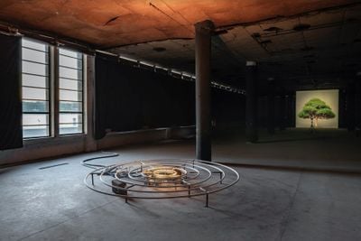 Left to right: Abbas Akhavan, spring (2021). Sculpture, frost, copper piping, freezing mechanism, cinder blocks, found water fountain, lights and pump. Part 1: 3.75 metres. Diameter x 45 cm, part 2: 160 x 160 x 80 cm (freezing mechanism).