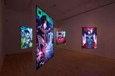 An installation of digital screens hanging in the gallery space feature Lu Yang dressed as her alter ego Doku in a futuristic setting.
