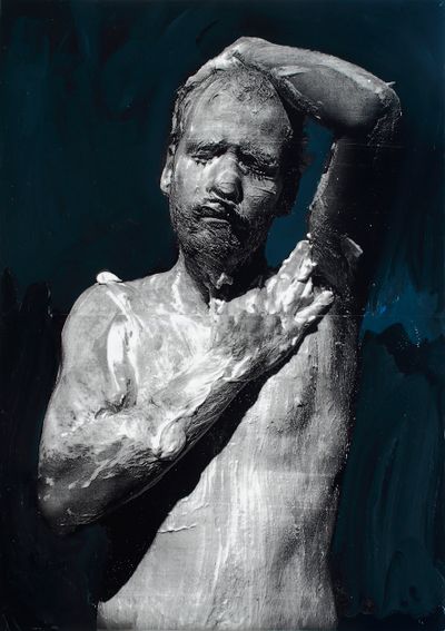 A painting of Mircea Suciu features the artist covering himself in foam, painted black and white against a blue-black background.