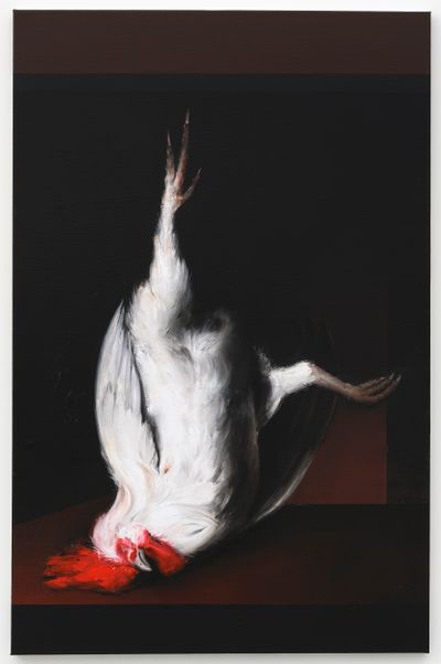 A dead rooster is painted against a black landscape, its white body and red crest standing out boldly against a black background.