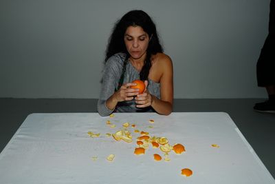 Moi Tran, Eating Oranges In Any Particular Manner (2018). Documentation of live performance.