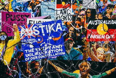 A painting of a group of people rioting by Richard Bell, holding placards that have phrases such as 'Australia Day = Invasion Day', with abstract strokes of paint across the surface.