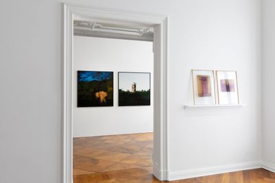 Four blurred photographs hanging on the walls of the exhibition space.
