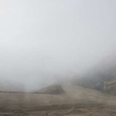 Photograph showing an open landscape swallowed by fog.