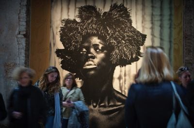 Poster of Zanele Muholi artwork, with a women gazing at the viewer at la Biennale di Venezia