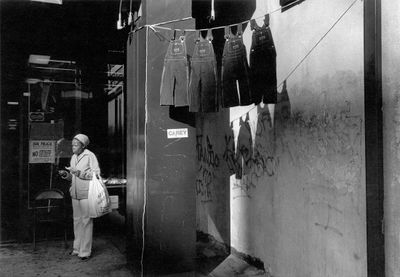 Dawoud Bey, A Woman with Hanging Overalls (1978). Photograph from 'Harlem, U.S.A.' series. © Dawoud Bey.