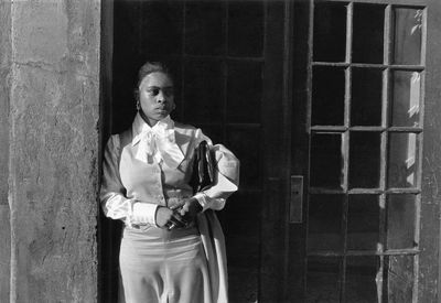 Dawoud Bey, A Woman Waiting in the Doorway (1976). Photograph from 'Harlem, U.S.A.' series. © Dawoud Bey.