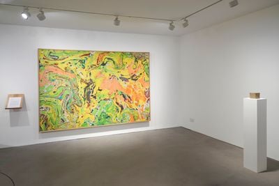 Left to right: Gala Porras-Kim, A terminal escape from the place that binds us (2021). Ink on paper and document. 185.5 x 267 cm; The Michael C. Rockefeller Wing at the Met 1982–2021 fragment (2022). Residue collected from the de-install of the M.C.R. Wing at the Metropolitan Museum, binder. 9.5 x 9.5 x 9.5 cm. Exhibition view: Out of an instance of expiration comes a perennial showing, Gasworks, London (27 January–27 March 2022).