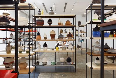 Pinaree Sanpitak, House Calls (2020). Mulberry paper, needles, found objects, and interchangeable shelves designed by Studiomake. Dimensions variable. Exhibition view: 100 Tonson Foundation, Bangkok (2020–2021).