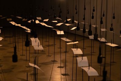 Shilpa Gupta, For, In Your Tongue, I Cannot Fit (2017–2018). Sound installation with 100 speakers, microphones, printed text, and metal stands. Exhibition view: Shilpa Gupta, Sun at Night, The Curve, Barbican Centre (7 October 2021–6 February 2022). © Tim Whitby/Getty Images.