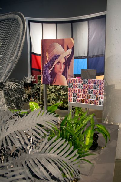 Stephanie Syjuco, Neutral Calibration Studies (Ornament + Crime) (2016) (detail). Wooden platform, neutral grey seamless backdrop paper, digital adhesive prints on lasercut wooden props, dye-sublimation digital prints on fabric, items purchased on eBay and craigslist, photographic prints, artificial plants, live plants, neutral calibrated grey paint. 25.4 x 50.8 x 20.32 cm.