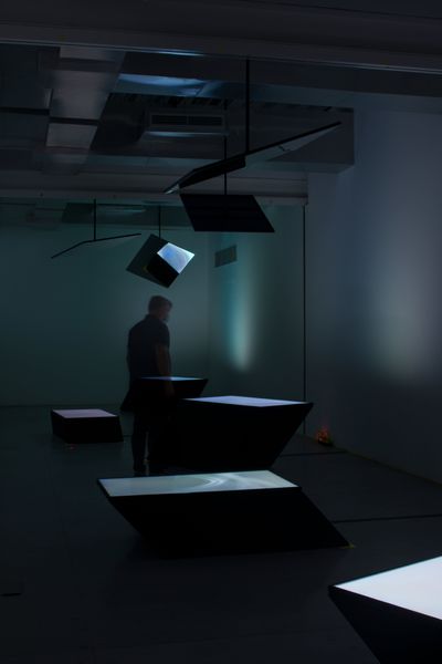 The Otolith Group, From Left to Night (2015). Five-channel 16:9 H.D. video installation with colour, no sound, mirrors, digital screens, plinths. Variable duration. Exhibition view: Xenogenesis, Sharjah Art Foundation (13 November 2021–6 February 2022).