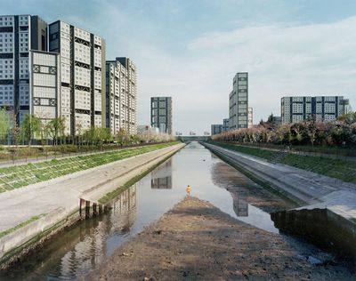 Tomoko Yoneda, River—view of earthquake regeneration housing project from a river flowing through a former location of evacuees' temporary accommodation, from the series 'A Decade After' (2004).