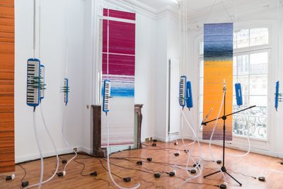 Tromarama, Beta (2019). Melodica, c-clamp, rope, soprano recorder, mic stand, DC fan, hose, hose clamp, chains, digital print on fabric, software, #nationality. Variable dimension. Exhibition view: Paris Internationale (2019).