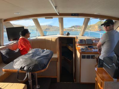 Yuki Kihara looking out to Potakere Port Chalmers with her production crew on the way back to base.