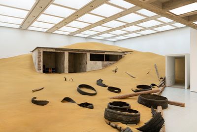 Mike Nelson, Triple Bluff Canyon (the woodshed) (2004). Various materials; M25 (2023). Found tyres. Exhibition view: Extinction Beckons