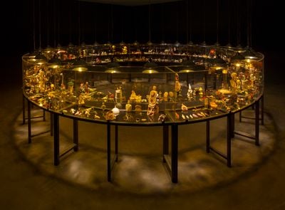 Mithu Sen, Museum of unbelongings (2016). Various personal objects, sculpted, morphed, and found; abandoned/impermanent/unusual belongings, memories, stories, and archives; motor-driven rotating steel table with acrylic vitrine. 166 x 400 cm (diametre).